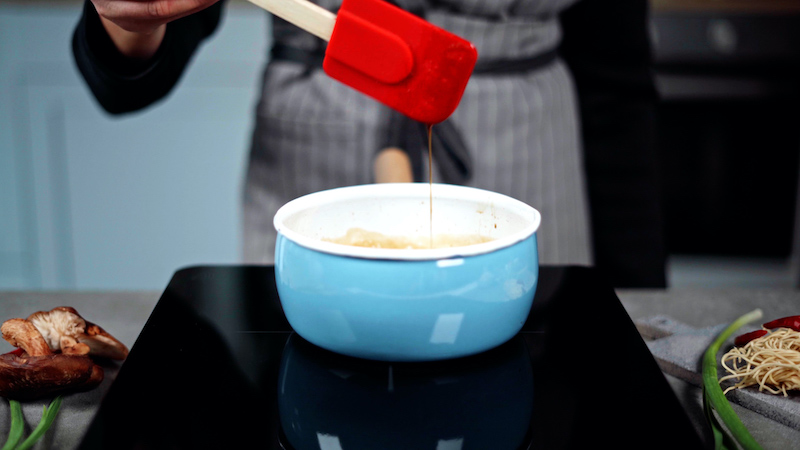 thickend sweet and sour sauce being tested on spatula