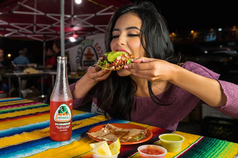weight gain woman eating a big taco