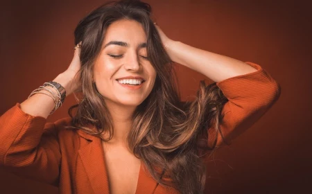 woman holding her hair and smiling