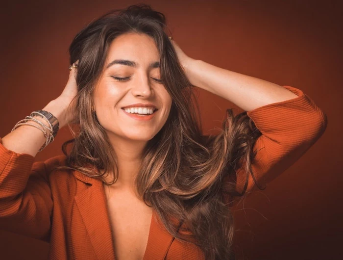 woman holding her hair and smiling