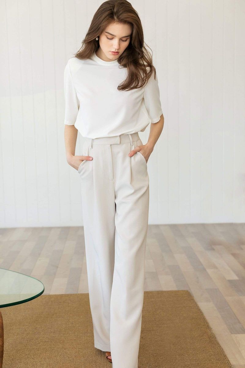 woman in all white dress pants and shirt