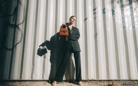 woman in black suit holding a bag