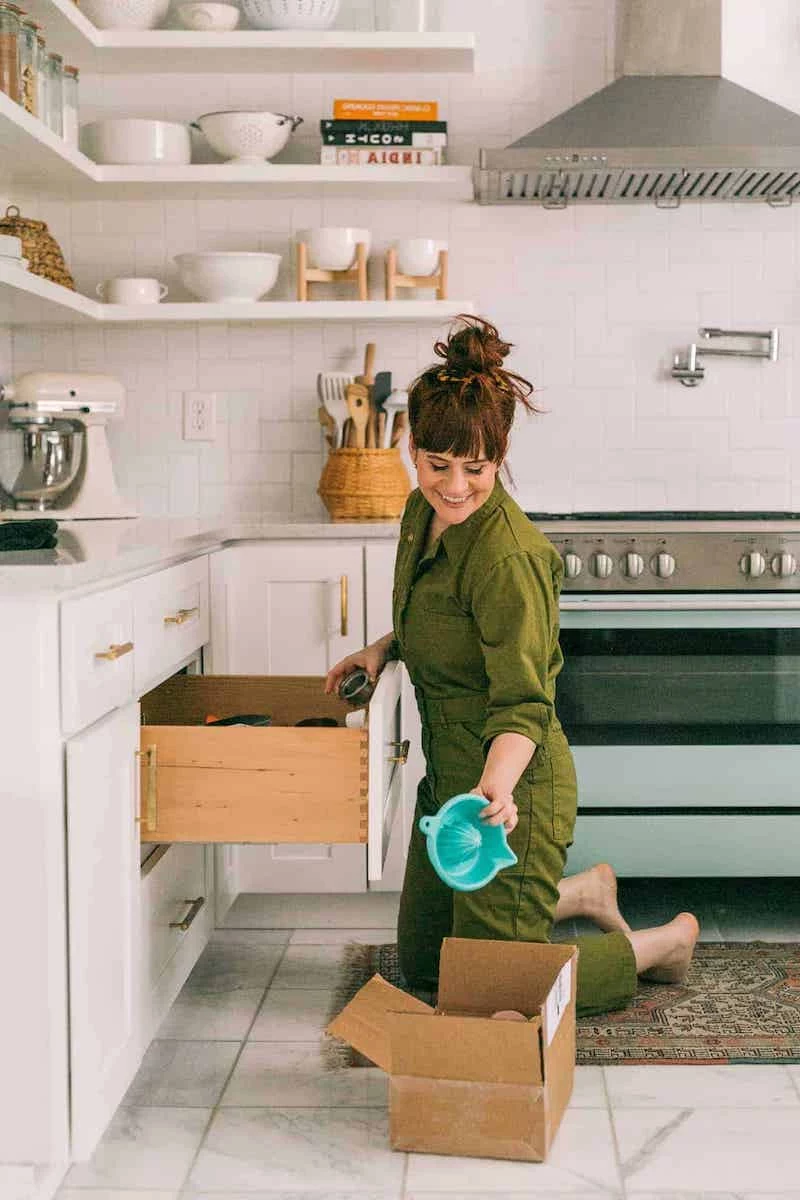 woman in the kitchen taking things out of drawer