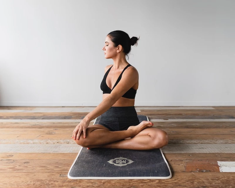 woman working out on a mat stretching