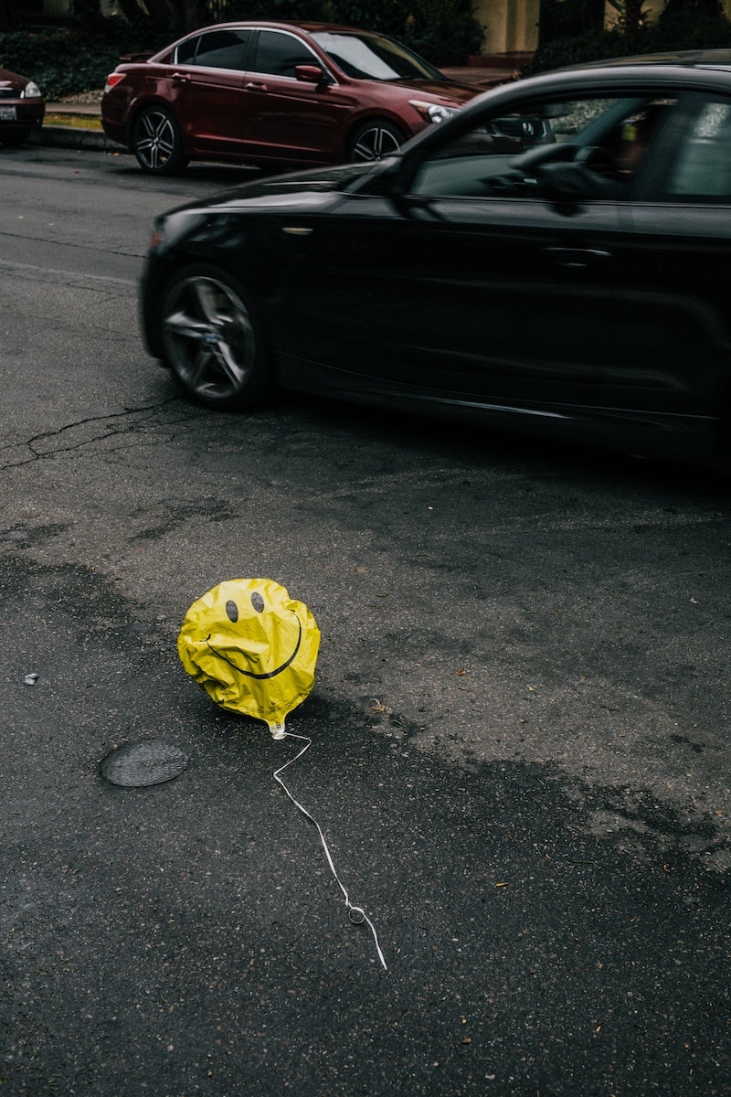 yellow smiley ballon face in the streets