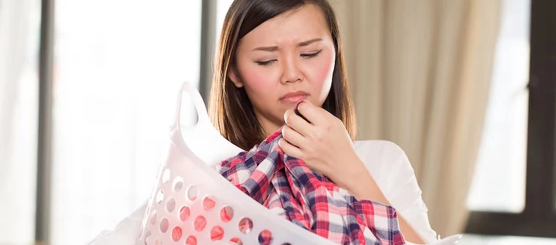 a woman unhappy with the smell of her laundry