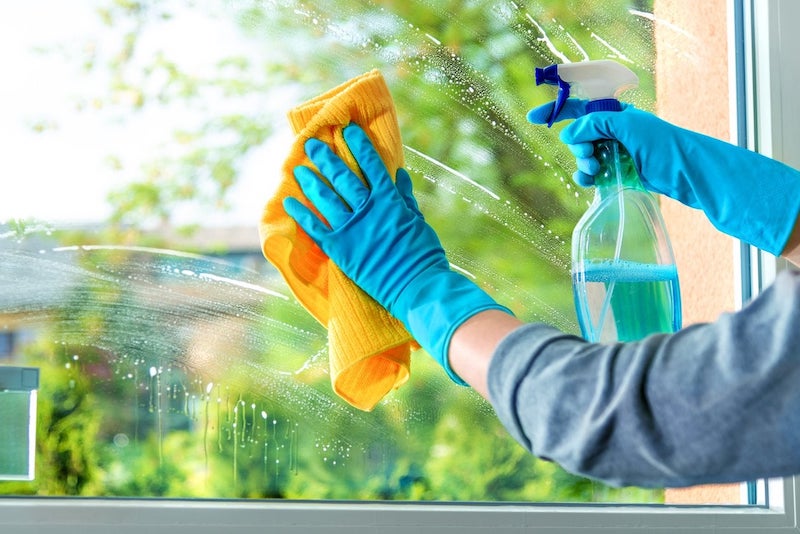 best ways to clean windows hand with rubber glove and towel cleaning soapy window
