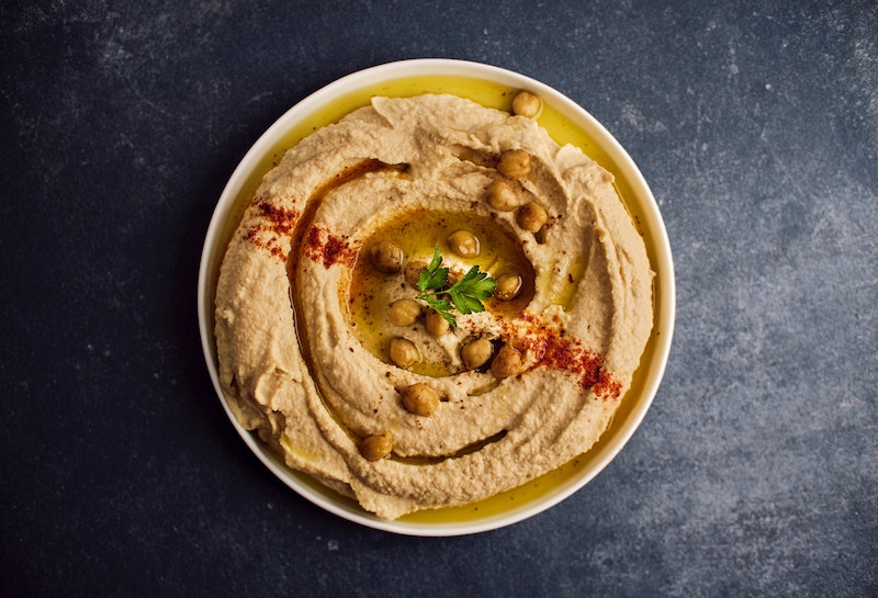bowl of hummus on a black table