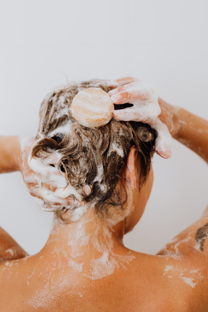 dandruff treatment woman shampooinh her hair