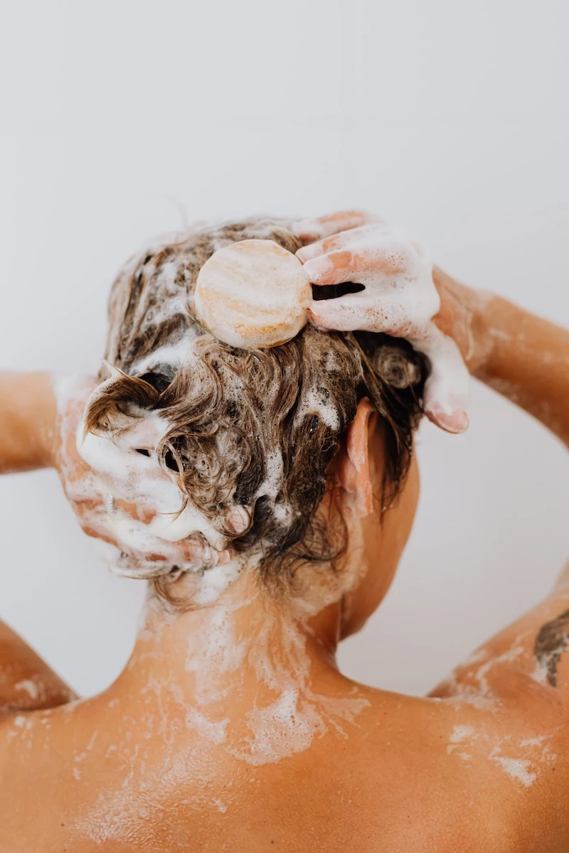 dandruff treatment woman shampooinh her hair