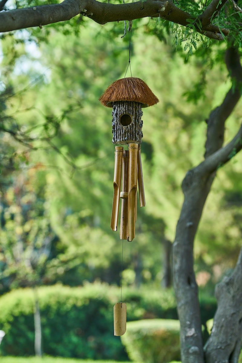 energy cleansing wind chimes and a bird house