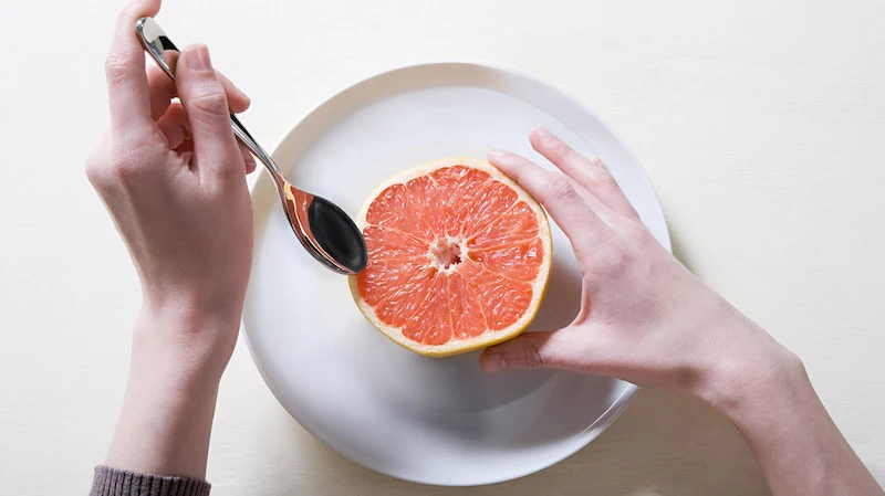 foods for weight loss eating a grapefruit with a fruit