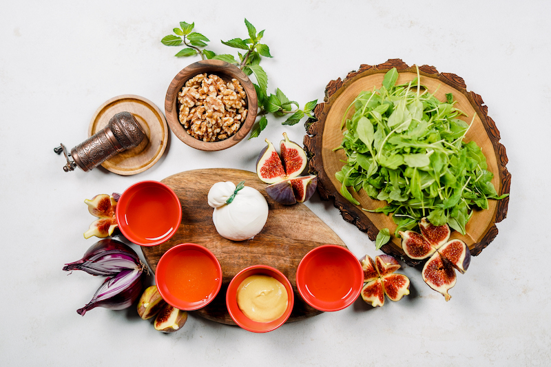 fresh summer salad with fig ingredients on a wooden board