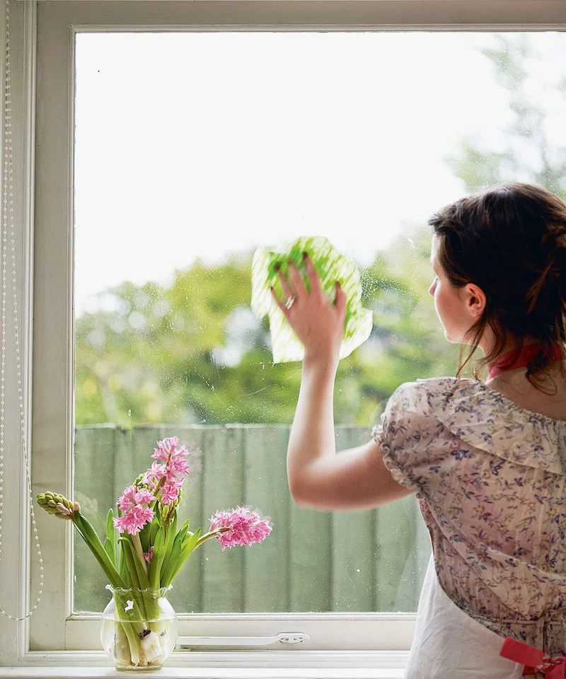 how to clean windows woman washing her window