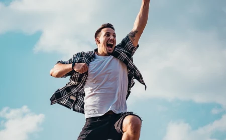 man jumping up with energy into air