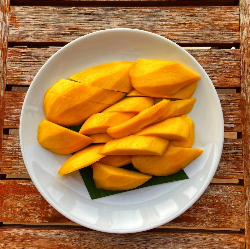 mango slices in a white plate