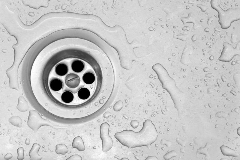 sink drain up close with water drops