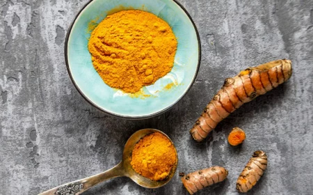 turmetic curcumicin powder next to turmeric root