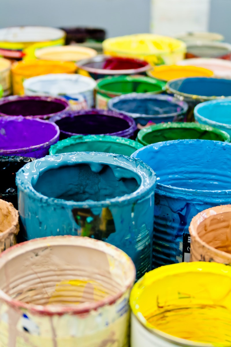 what not to pour down the drain colorful empty paint buckets