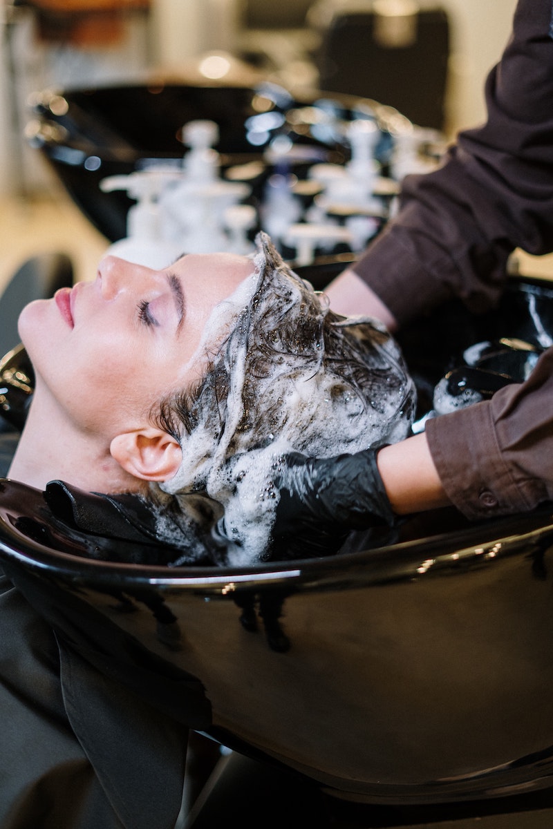 woman getting her hair shampooed at a salon