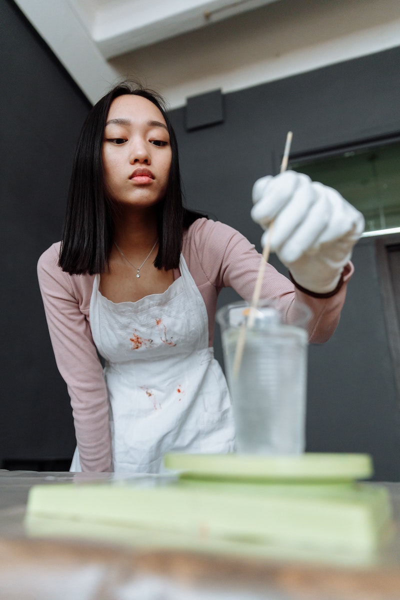 woman mixing resin in a plastic cup