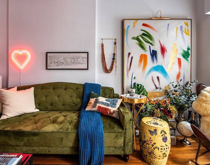 A modern eclectic living room with brilliant pops of color can still be cluttered