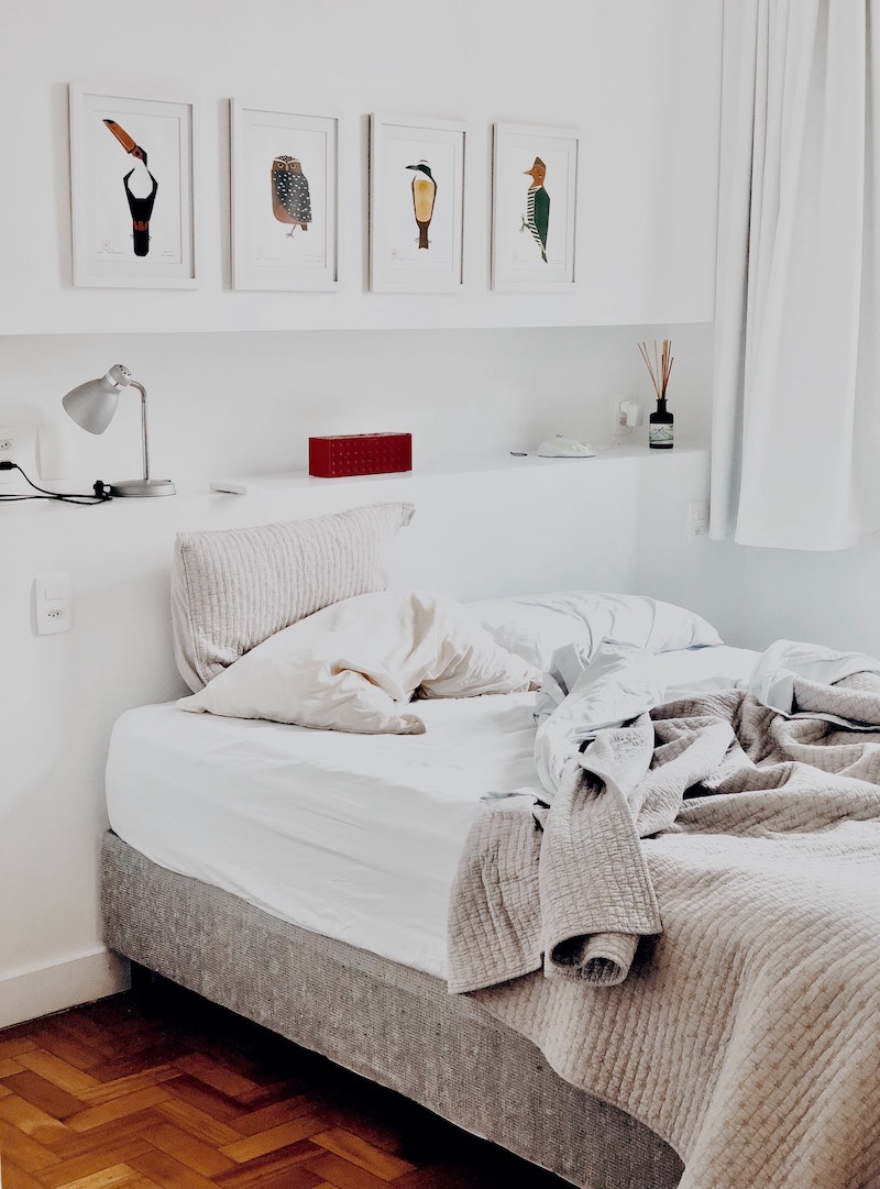 bedroom with messy white sheets