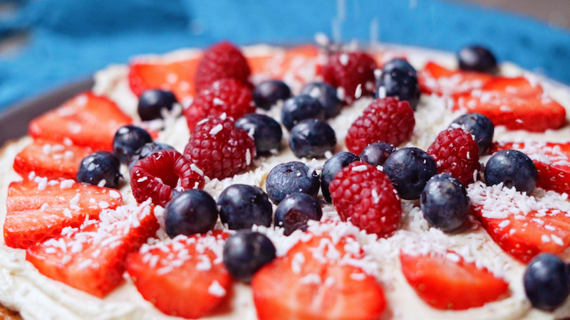 coconut flakes and berries on dessert pizza