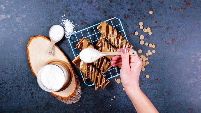 coconut flakes spinkled on homemade twix bars