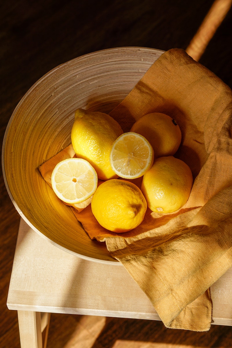 diy stain remover whole and cut lemons in bowl