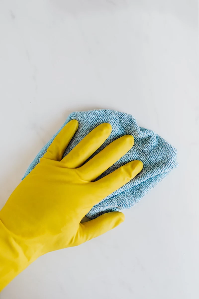 hand scrubbing with yellow rubber gloves and towel