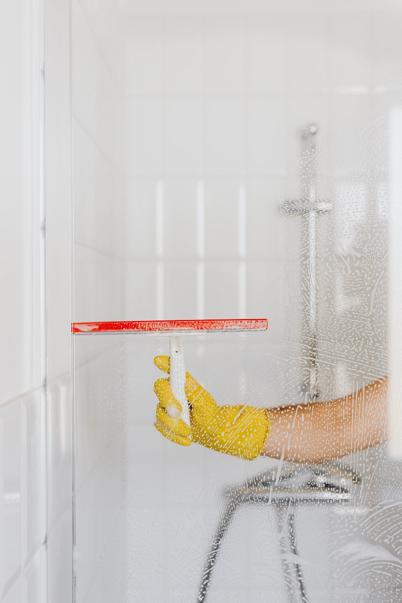 how to clean a shower person cleaning shower glass
