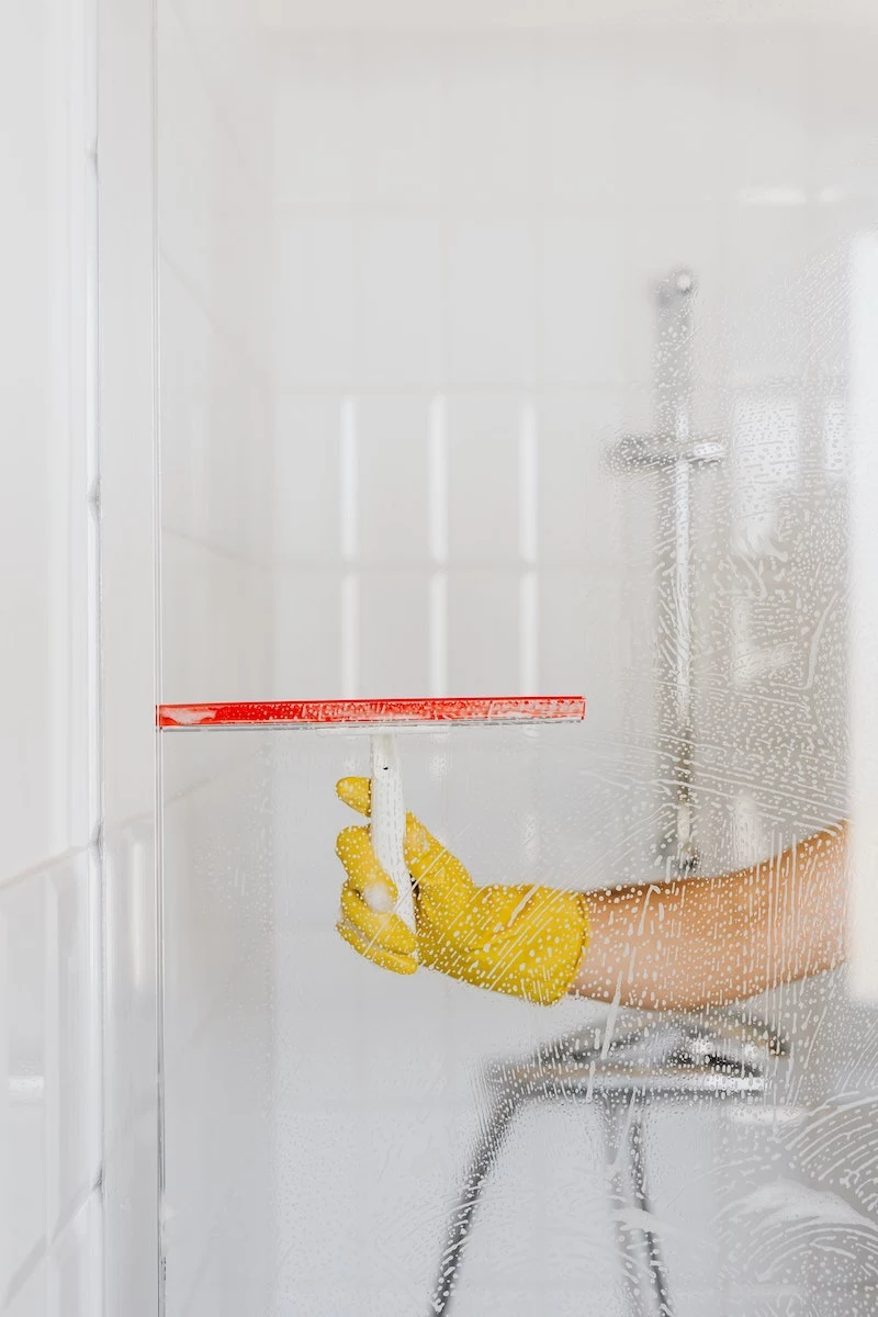 how to clean a shower person cleaning shower glass