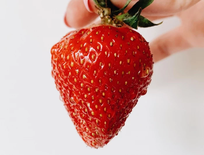 how to get rid of strawberry legs strawberry being held by the stem