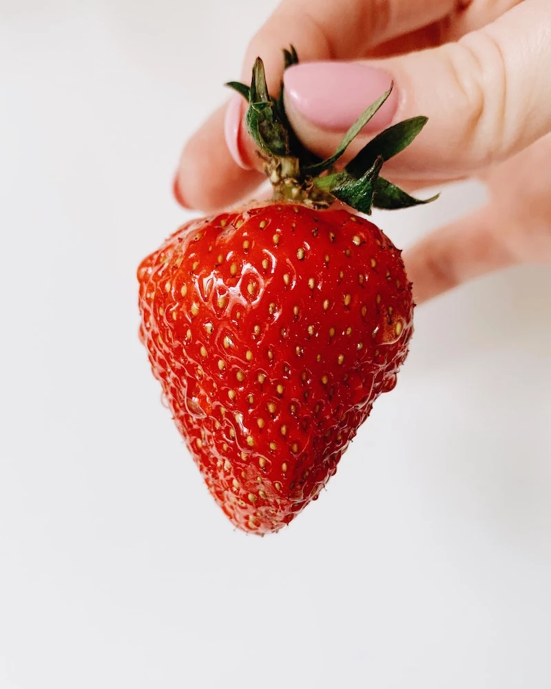 how to get rid of strawberry legs strawberry being held by the stem