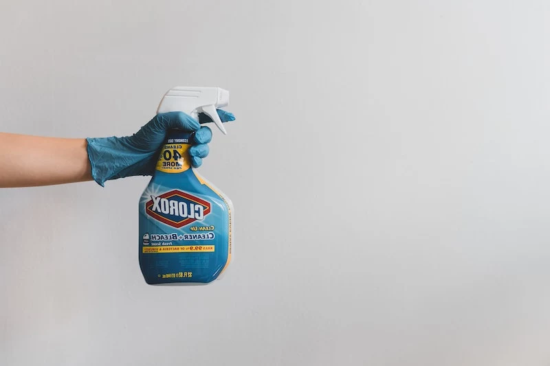 how to get rid of yellow stains bleach spray being held