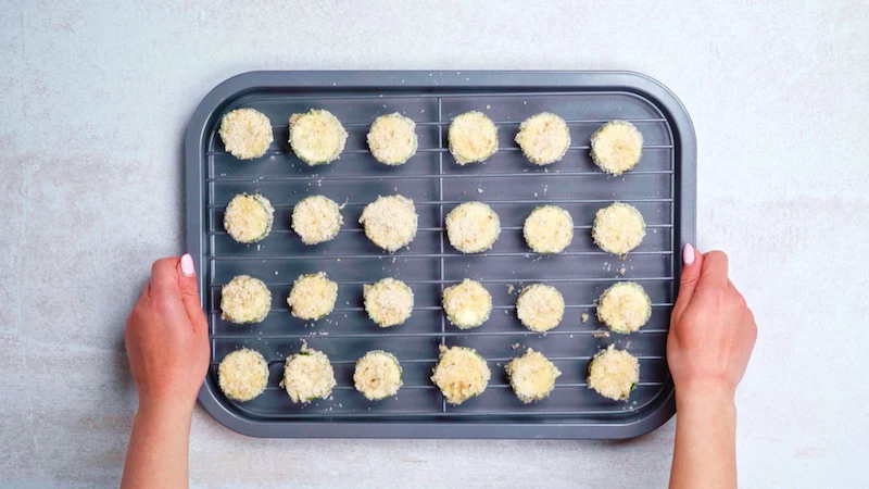 keto zucchini bites on a cooking rack on a baking pan