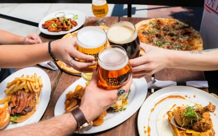 people giving cheers at table with beers