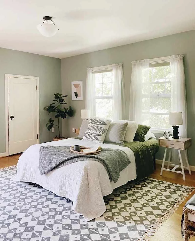 sage green bedroom with white bed