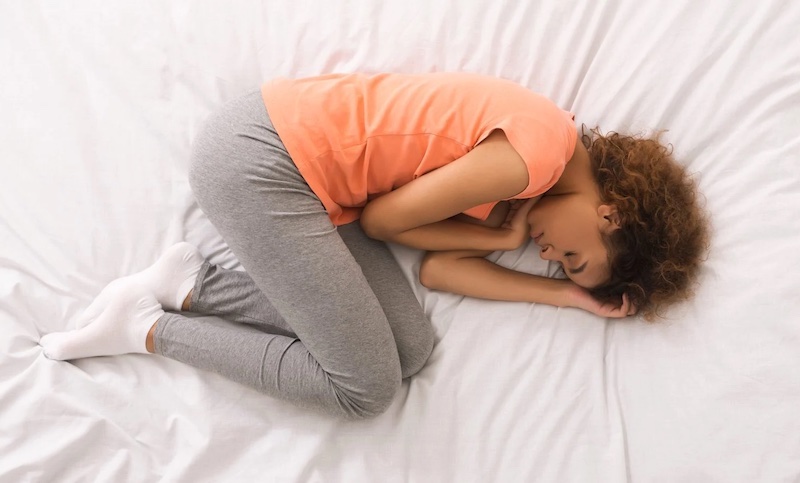 woman sleeping in a fetal position