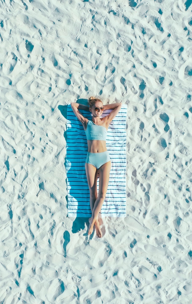 woman sun bathing on the beach