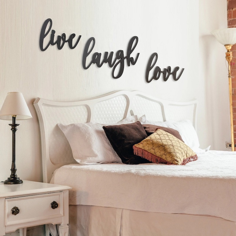 your home looks cheap live laugh love in black above bed