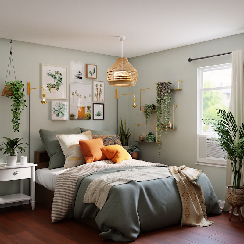 bedroom with light blue gray and orange sheets