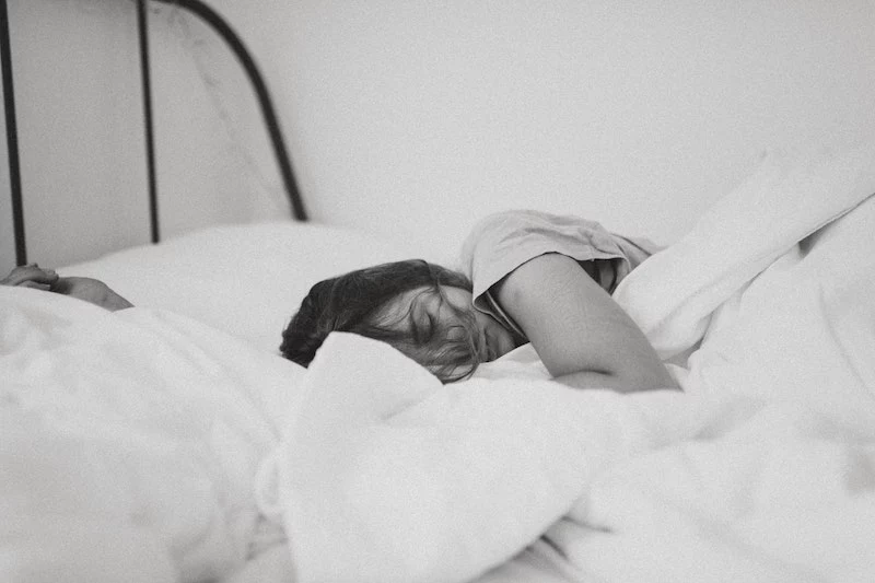 black and white woman sleeping in bed