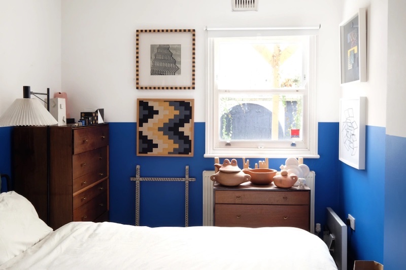 blue and white bedroom with bed and shelf