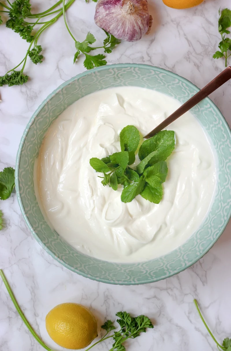 bowl of greek yogurt with mint leaves