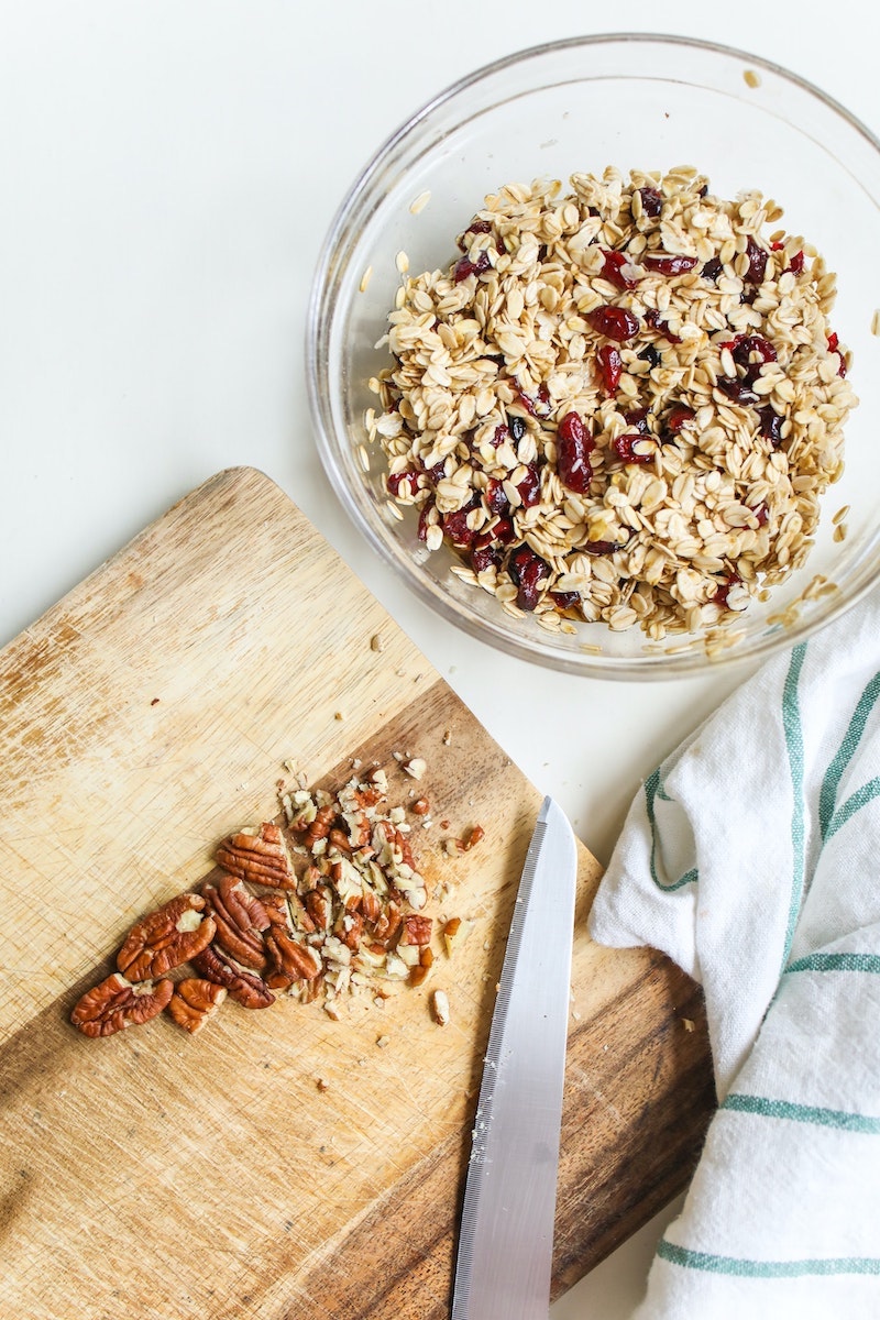 bowl of oats with chopped pecans on the side