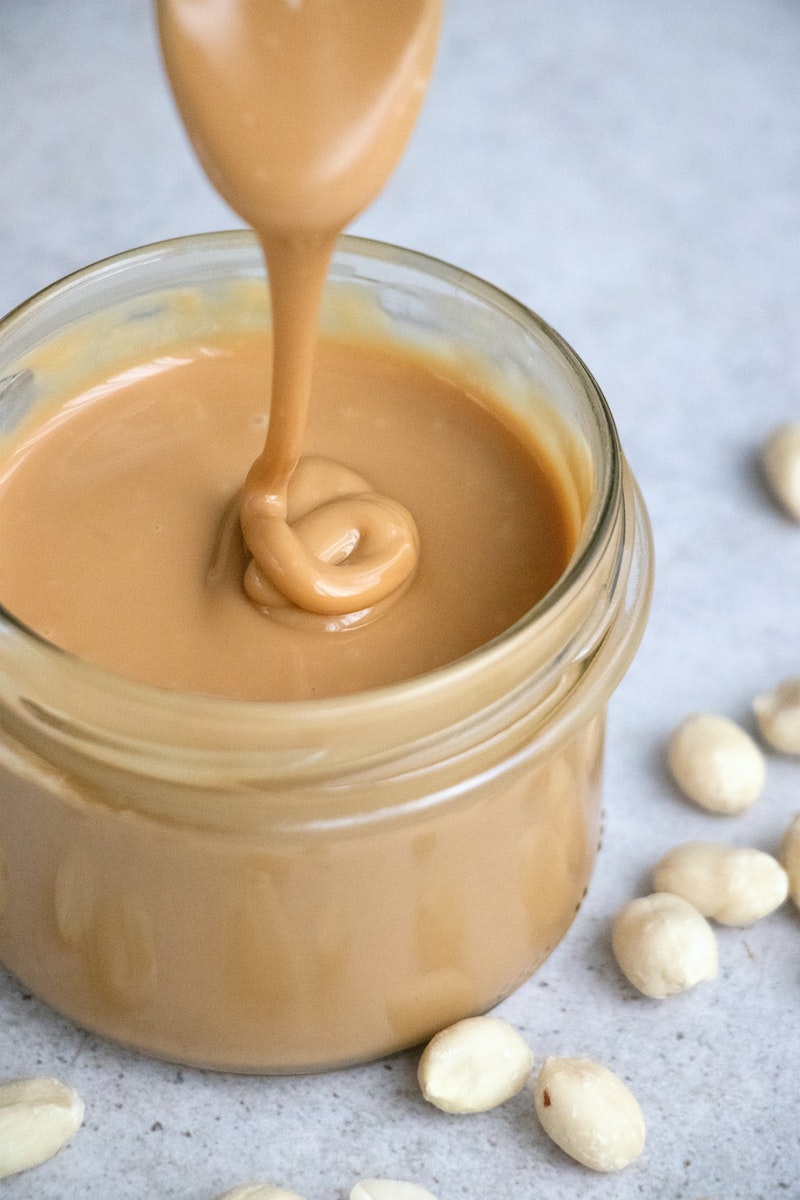 creamy peanut butter in a glass jar