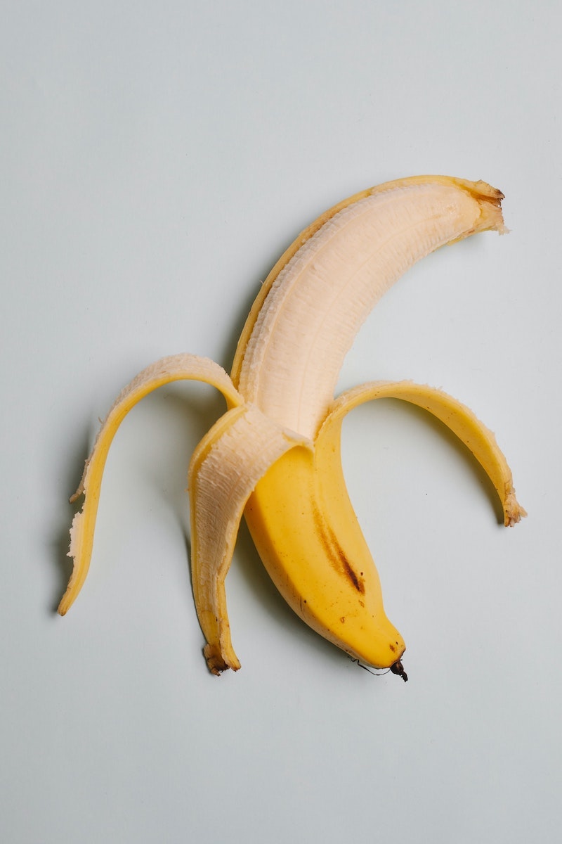 healthy breakfast foods peeled banana on white background
