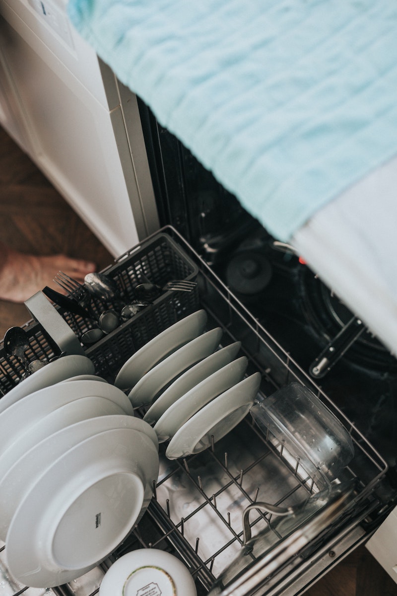 how to clean a dishwasher dishwasher filled with white plates